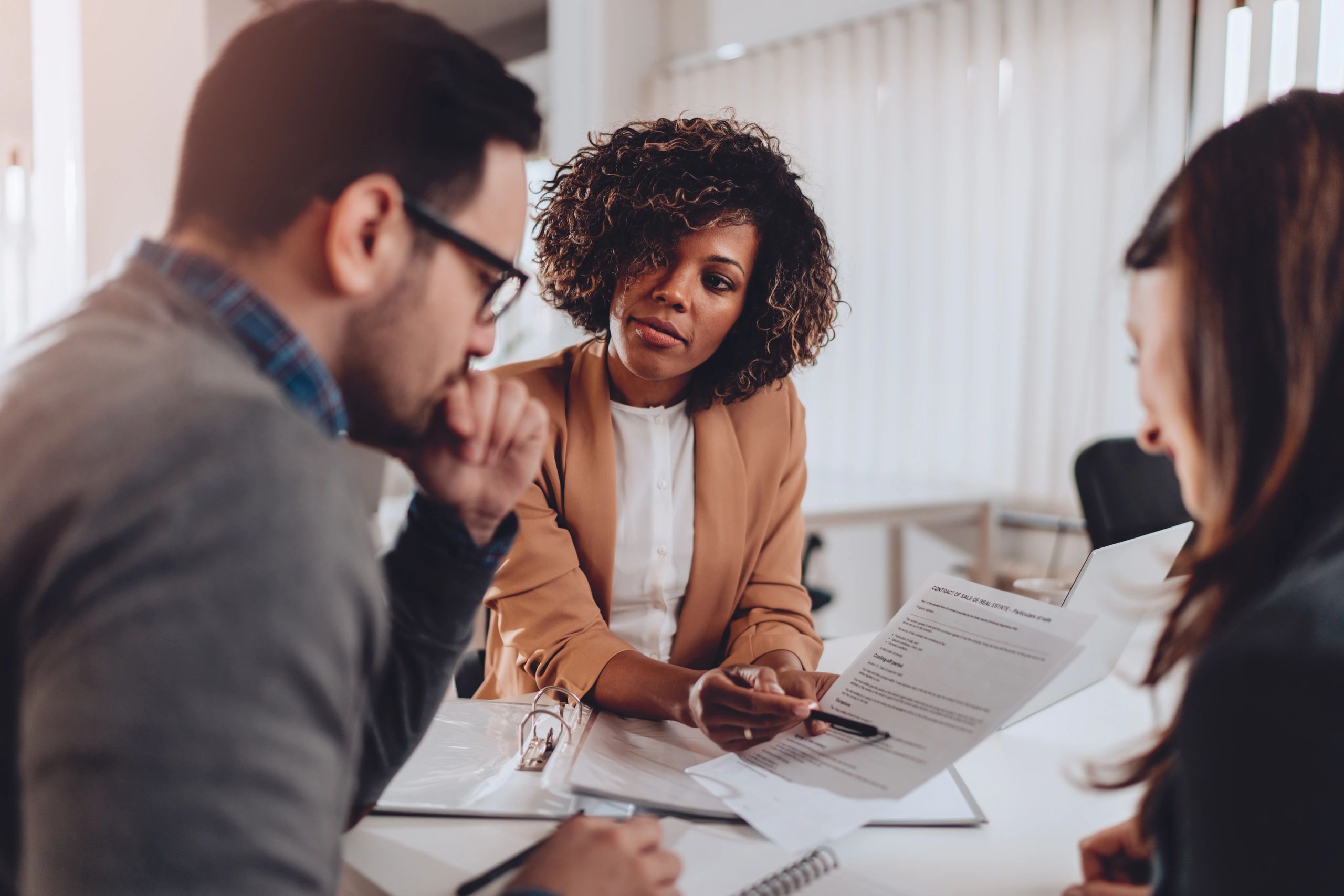 Clients reviewing property documents with an advisor