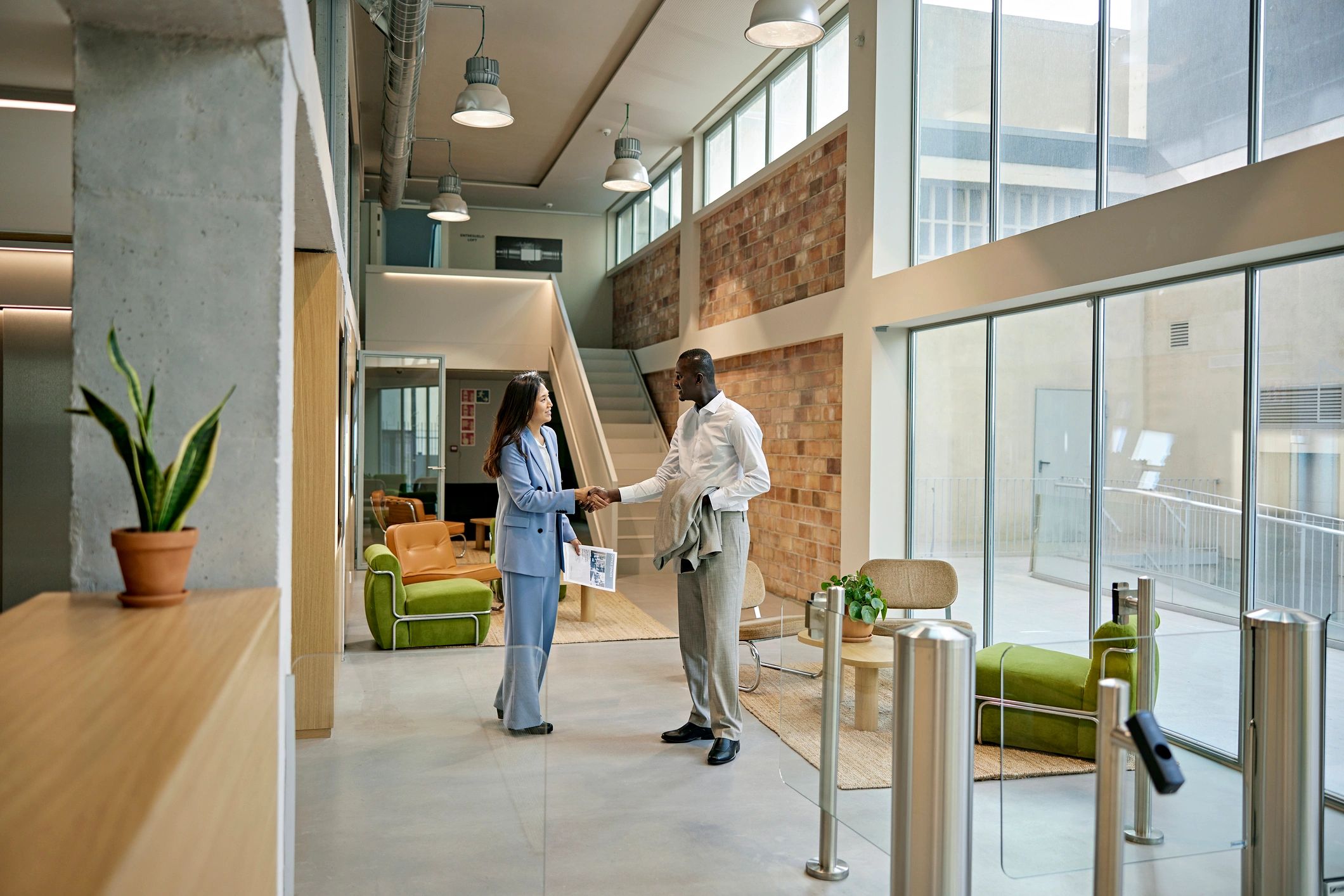Real estate agent greeting a client in a modern property setting